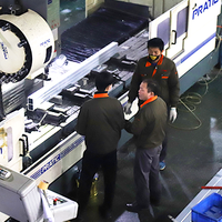 CNC machine operators working on production